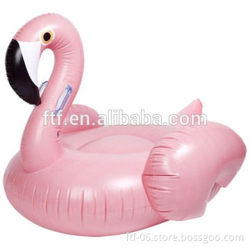 pink inflatable swimming flamingo